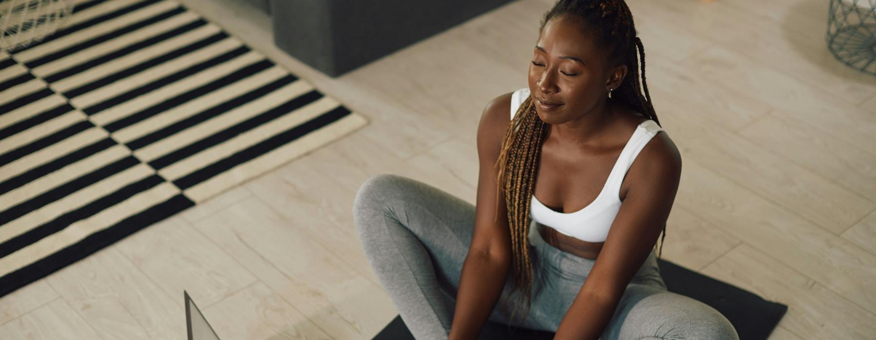 woman sitting on a yoga mat
