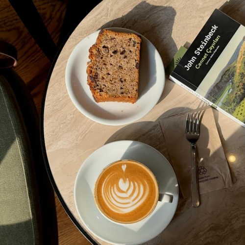 a plate of food and a cup of coffee on a table