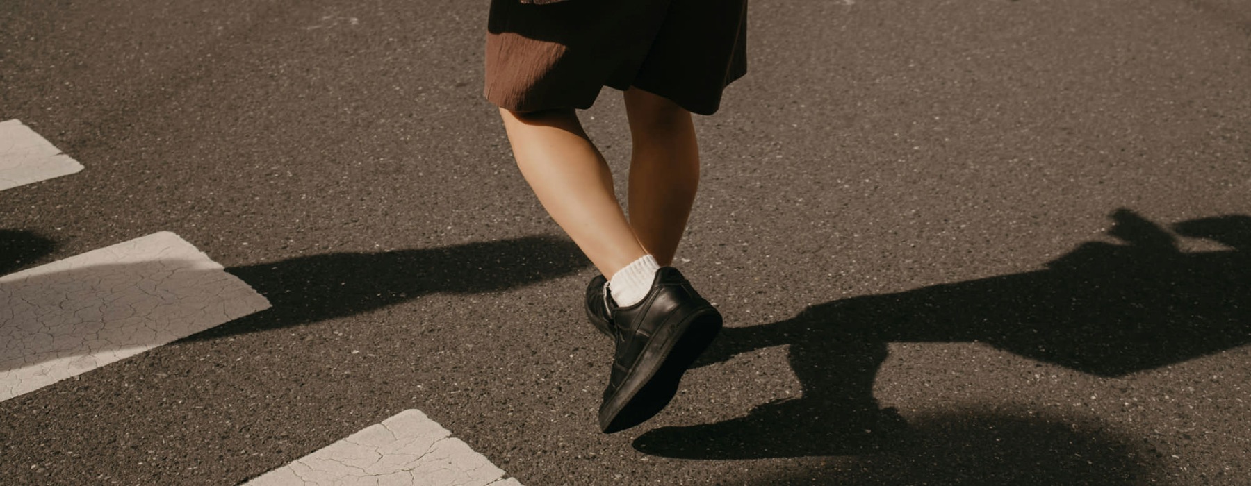 a person walking across a crosswalk