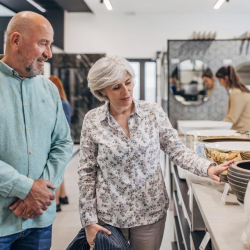 a man and woman shopping for dishes