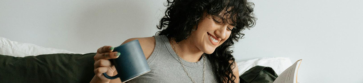 The essence of exceptional living Woman having coffee on a couch